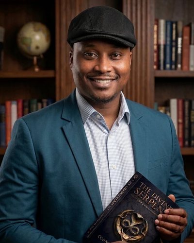Cornelius M. Clay II, author of The Divine Serpent, holding a copy of the book